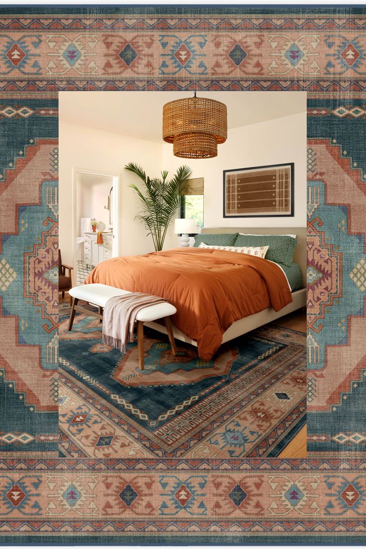 a bed with an orange comforter on top of it in a bedroom next to a rug