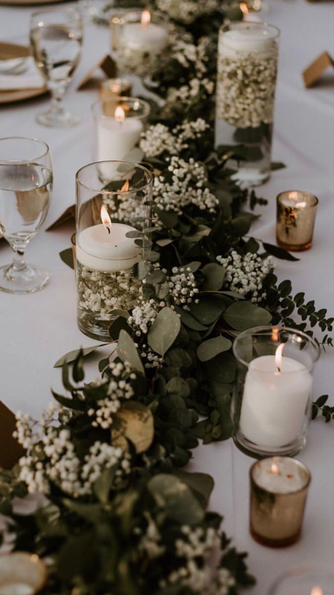 a long table with candles and flowers on it