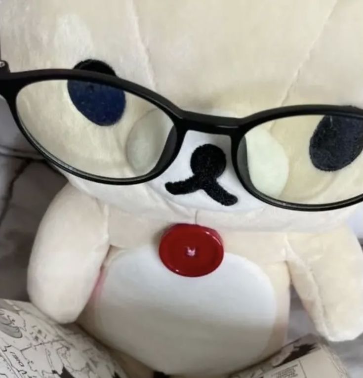 a white teddy bear with glasses on it's face