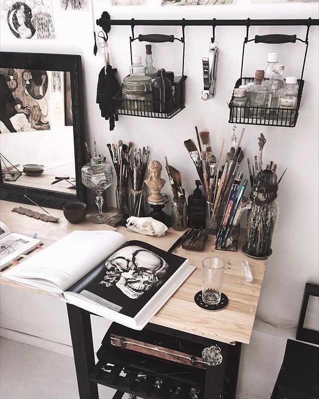 a desk with many items on it in front of a mirror