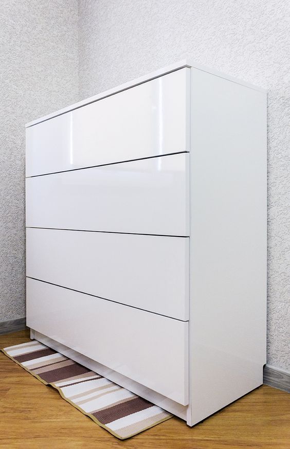 a white dresser sitting on top of a hard wood floor