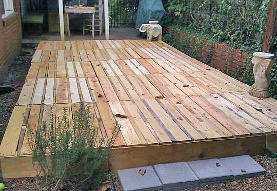 a wooden deck in the middle of a yard