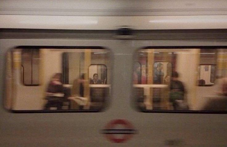 people are sitting on the subway train as it passes by