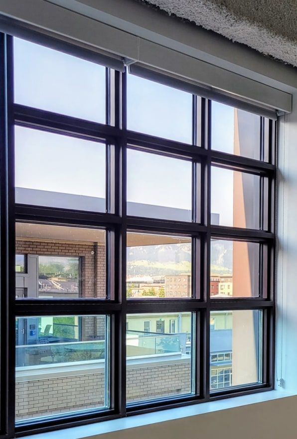 an open window with the view of buildings outside