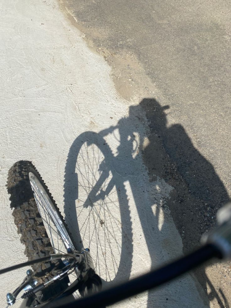 the shadow of a person on a bike