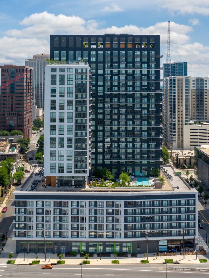 an aerial view of two tall buildings in the city