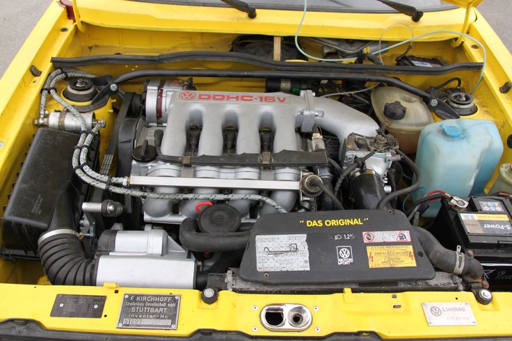 the engine compartment of a small yellow car