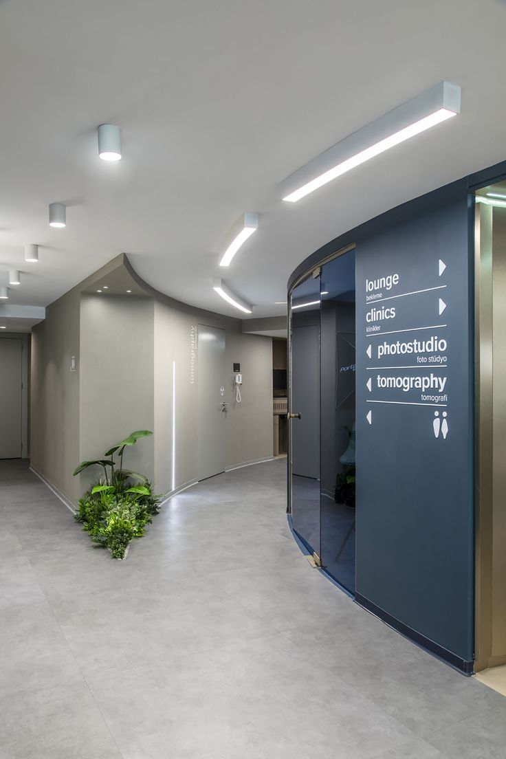 an empty room with signs on the walls and plants in the corner next to it