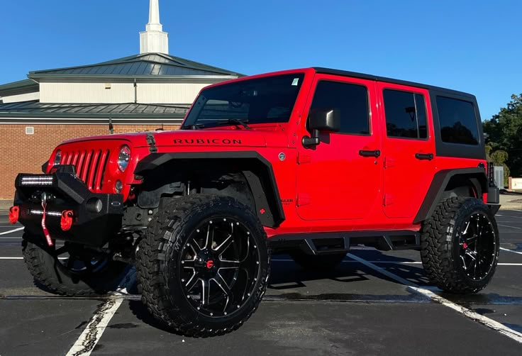 a red jeep parked in a parking lot