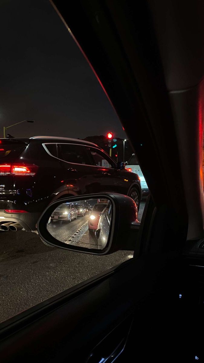 the rear view mirror of a car at night