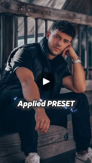 a man sitting on top of a wooden bench