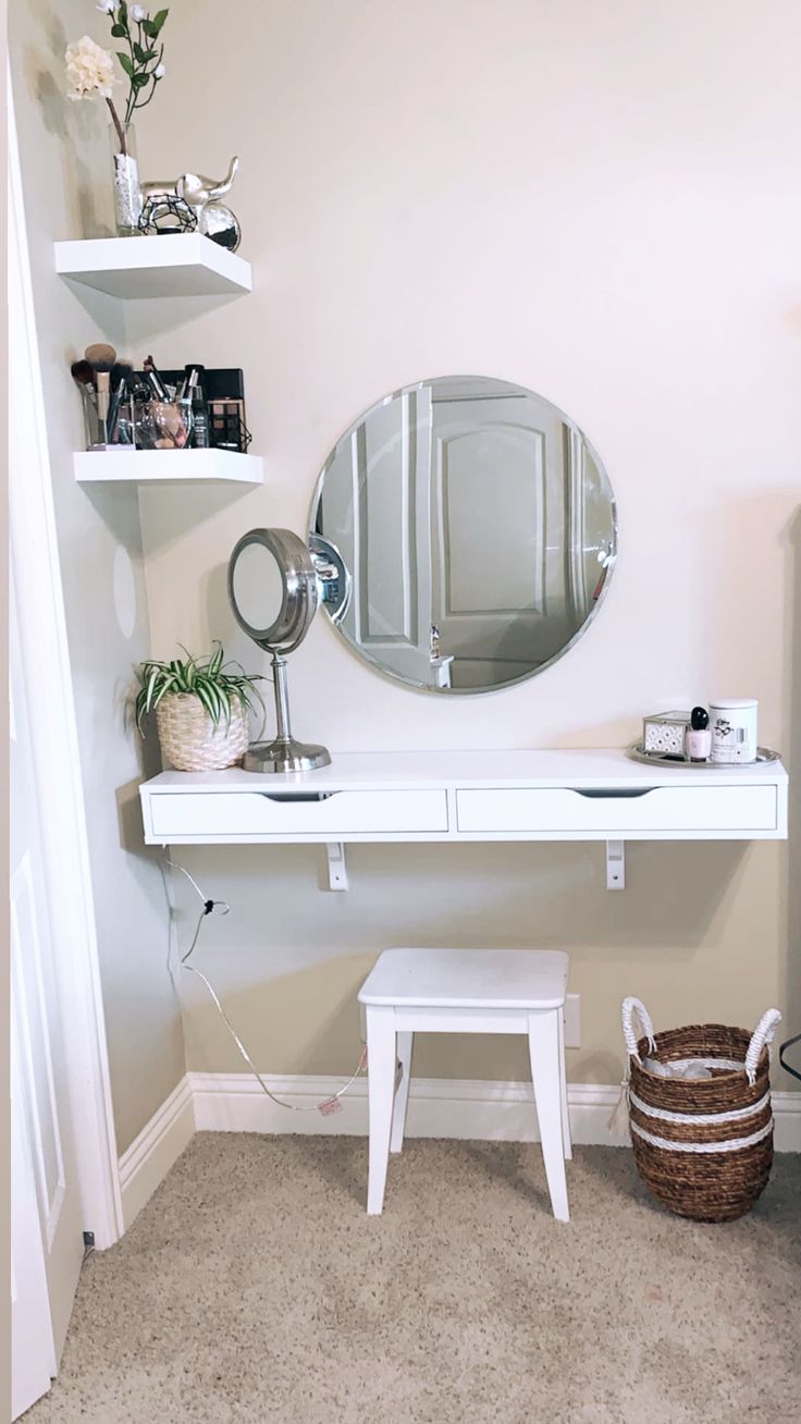 a white desk with a mirror, stool and shelves on the wall in a room