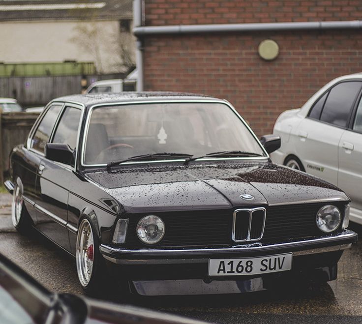 two cars parked next to each other on the street