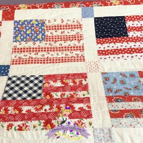 a red, white and blue quilt is on display