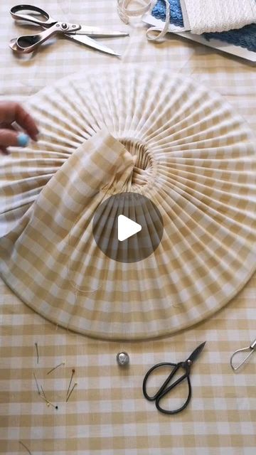 a table topped with scissors and other crafting supplies on top of a checkered table cloth