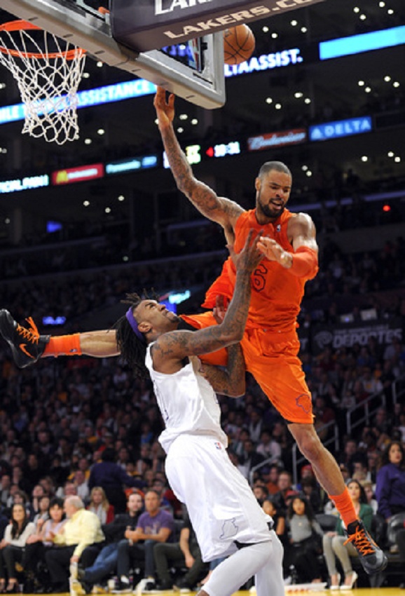 two men playing basketball in front of an audience