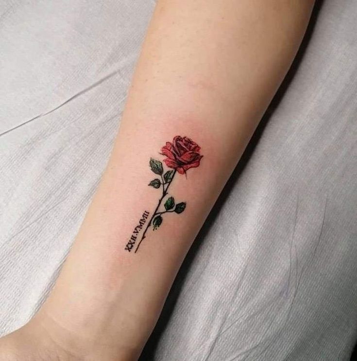 a small rose tattoo on the wrist