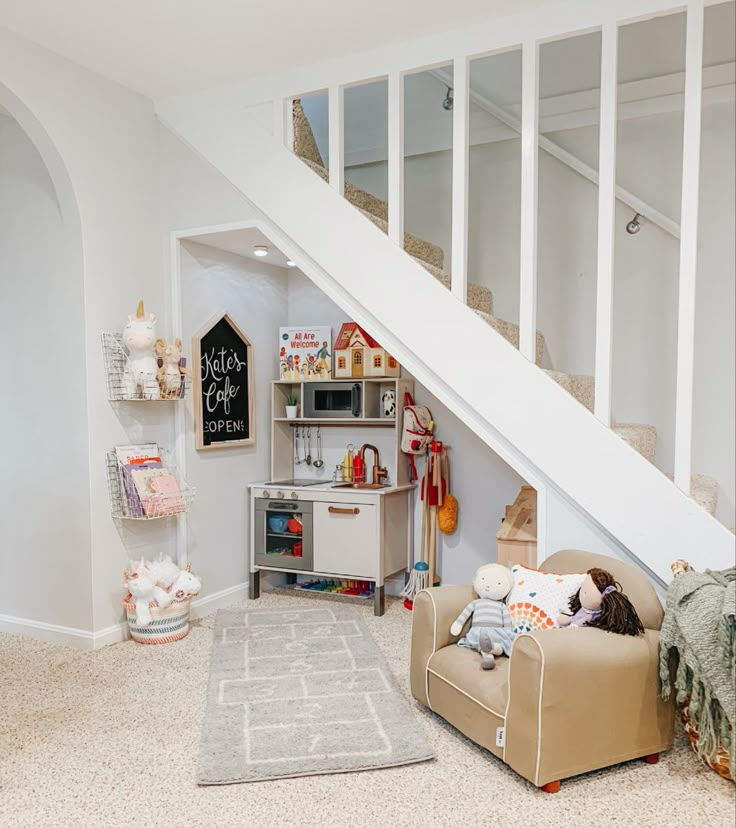 a child's playroom under the stairs in a house