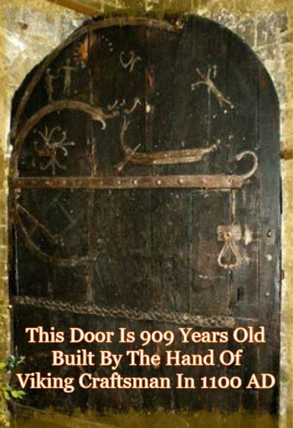 an old wooden door with writing on it