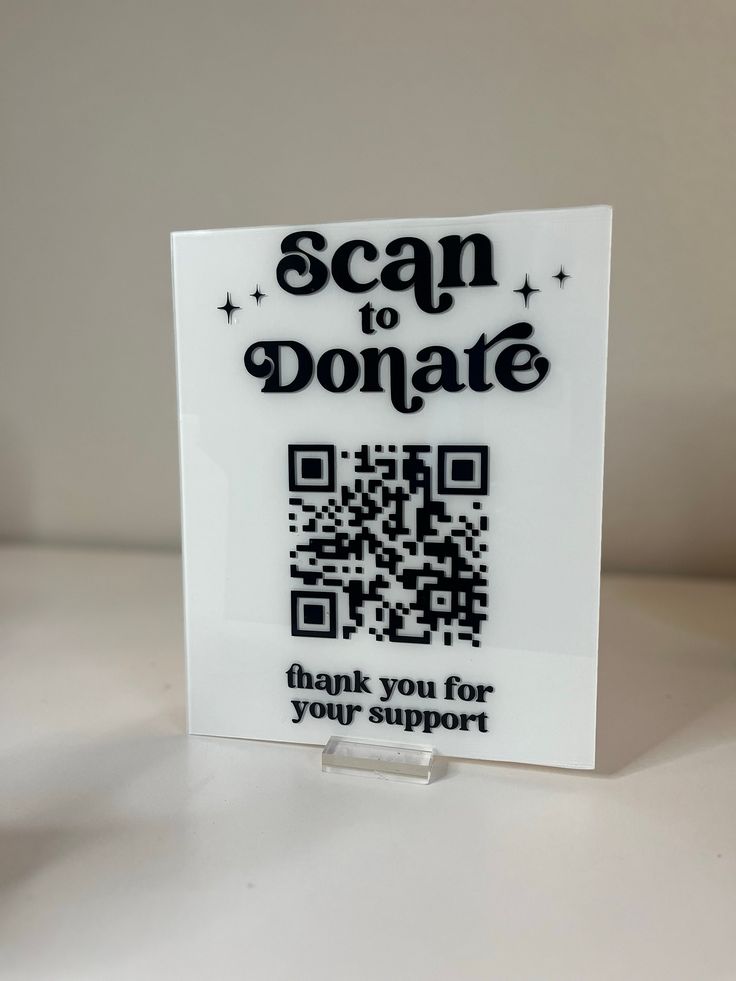 a qr - code card that says scan to donate