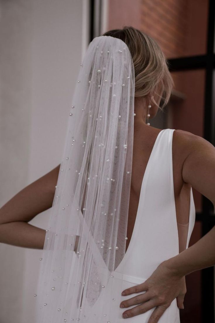 the back of a woman wearing a wedding veil