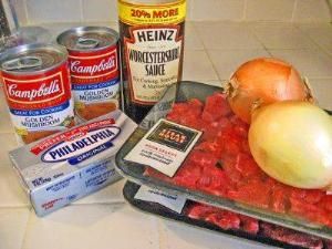 an assortment of food items including meat and vegetables on a counter with condiments