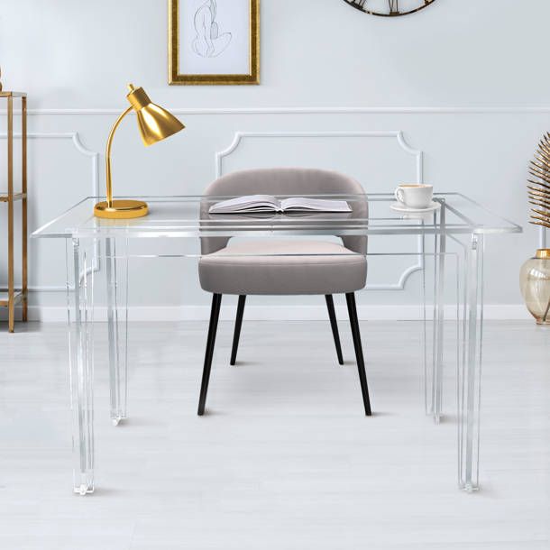 a glass desk with a chair and clock on the wall behind it in a white room