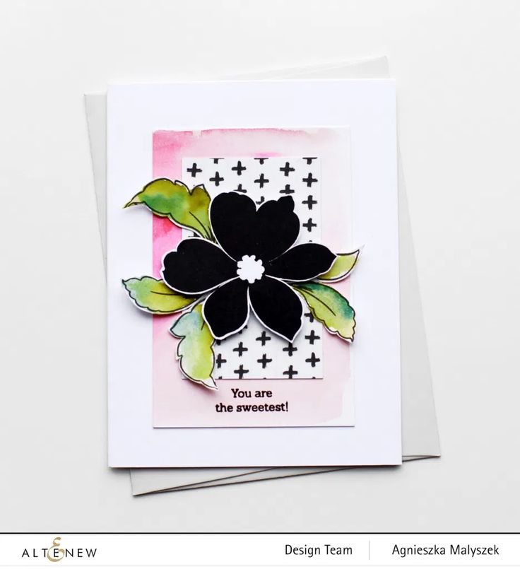 a card with some black and white flowers on it