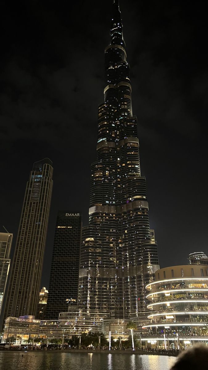 the burj building is lit up at night