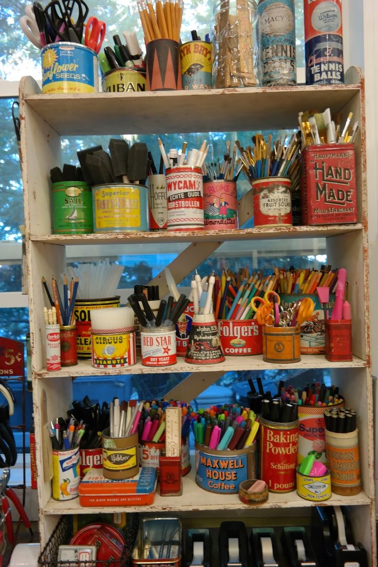 a shelf filled with lots of different types of pens, pencils and other office supplies