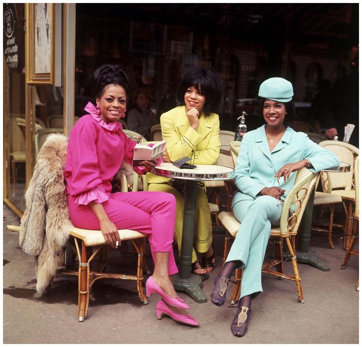 three women are sitting at a table together