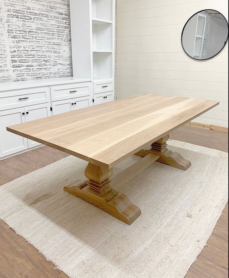 a wooden table sitting on top of a white rug