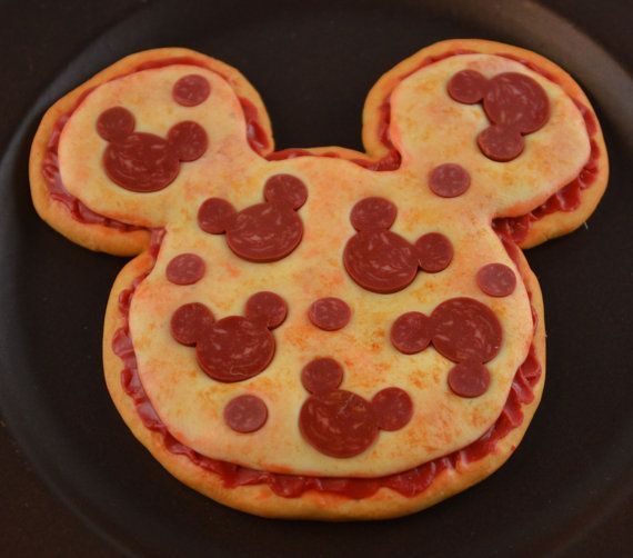 a mickey mouse pizza on a black plate