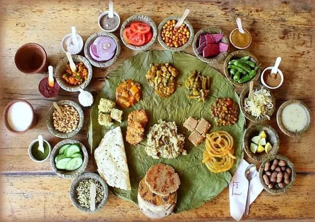 a wooden table topped with lots of different types of food and condiments on top of it