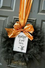 a door hanger with an orange bow on it that says enter if you dare