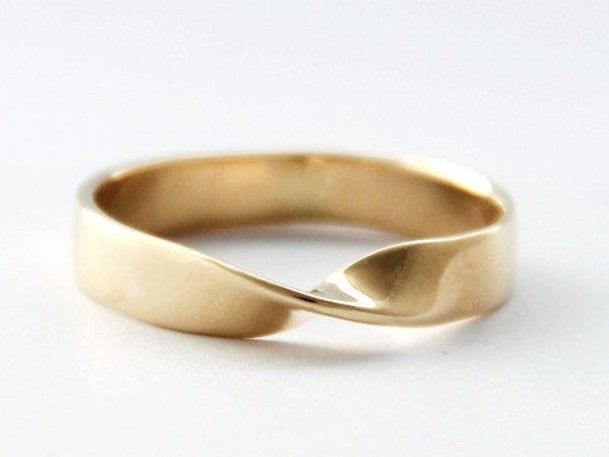 a yellow gold ring with two curved edges