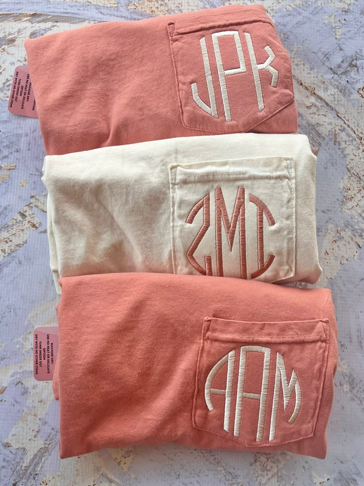 three monogrammed towels are laying on a bed