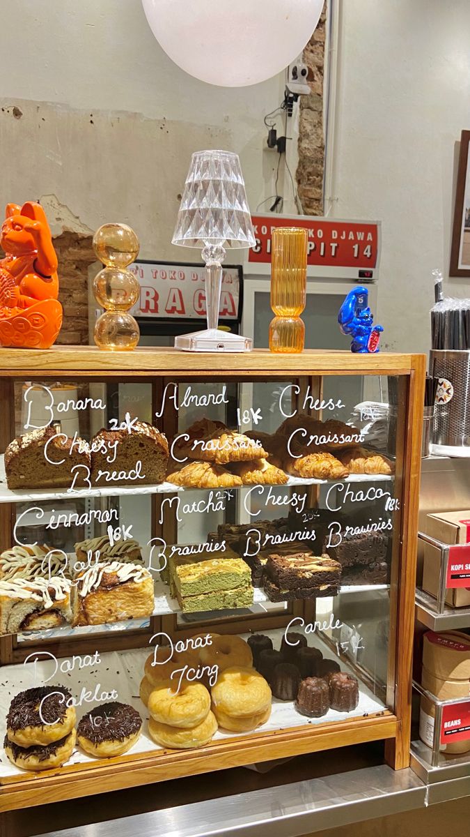 a display case filled with lots of different types of doughnuts and pastries