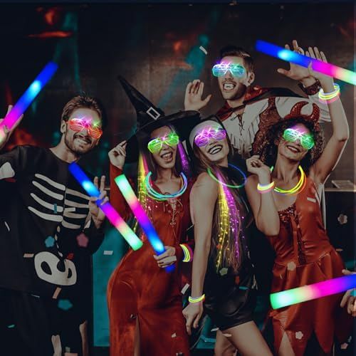 a group of people in costume posing for a photo with neon lights on their faces