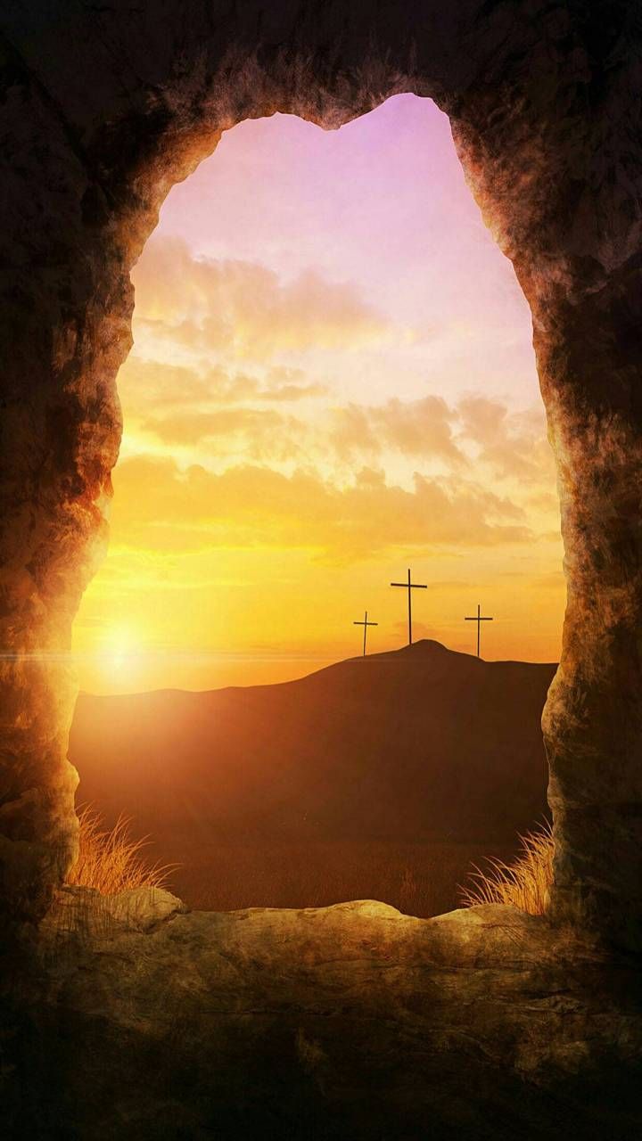 the sun is setting behind three crosses on top of a hill with hills in the background