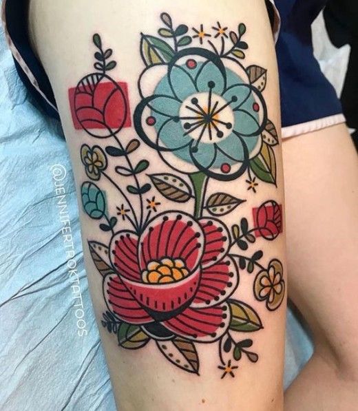 a woman's thigh with flowers and leaves on it