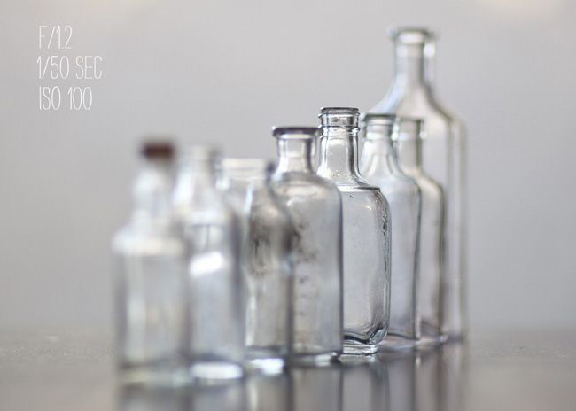 several empty glass bottles lined up on a table