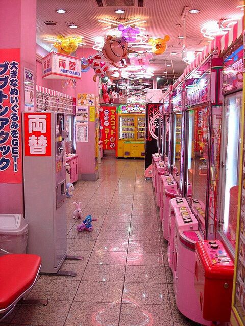 a pink room filled with lots of vending machines