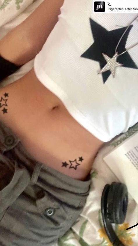 a woman laying in bed with her stomach tattoo