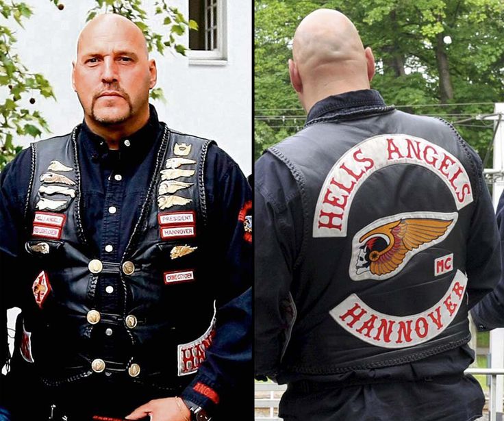 two men dressed in leather jackets and one wearing an eagle patch on the back of his jacket