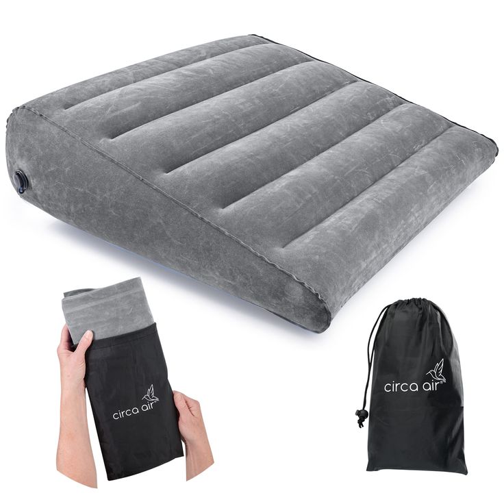 an inflatable air mattress is being held up by someone's hand and two draws