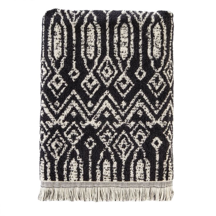 a black and white rug with fringes on it, in the shape of an abstract pattern