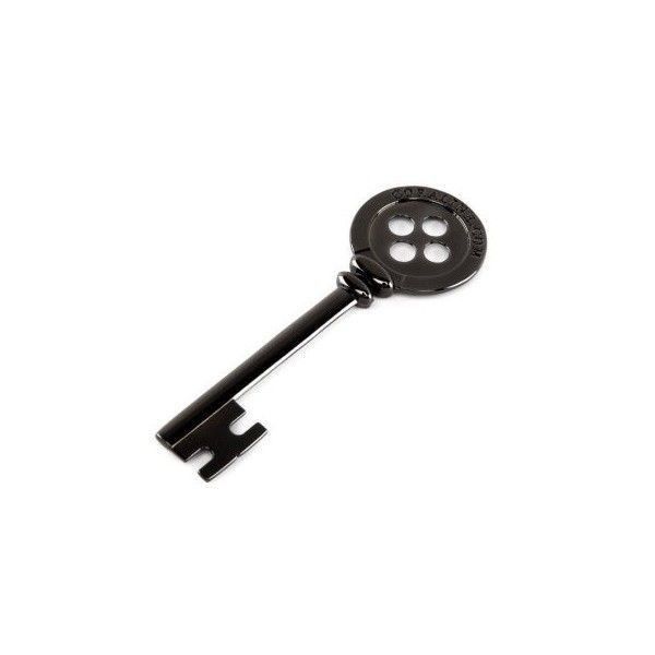 a black key with four holes on the front and back side, attached to a white background