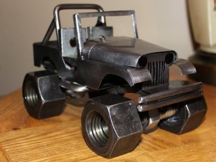 a metal toy truck sitting on top of a wooden table