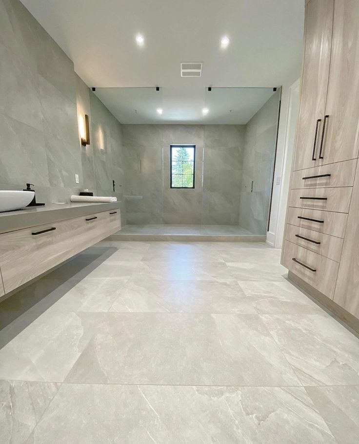 a large bathroom with marble floors and white walls